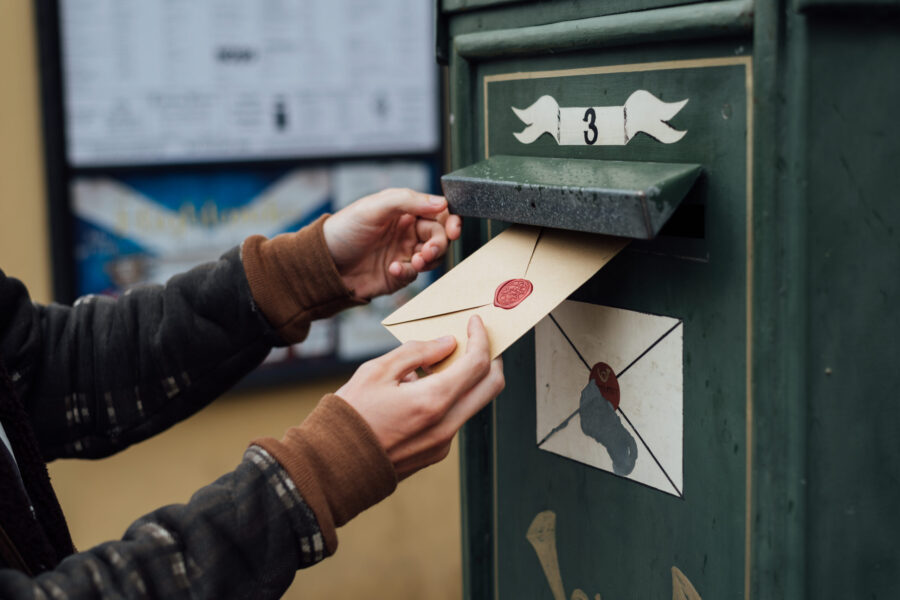 Mailing letter with wax seal to old postbox on street
